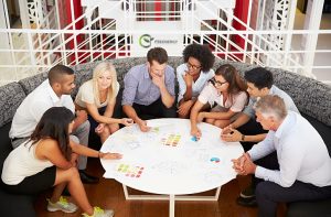 Group of FSS Energy work colleagues having meeting in an office lobby